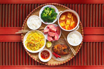 Vietnamese style family lunch set for two persons on red vintage table background