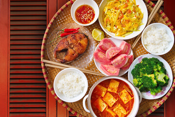 Vietnamese style family lunch set for two persons on red vintage table background