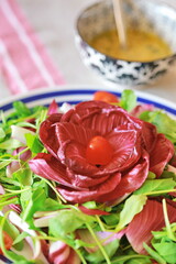 Mixed salad dish made from red chicory, tomato and cruciferous vegetables