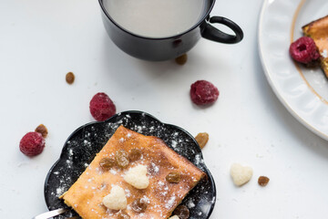 Appetizing curd casserole. Nearby is a drink and raspberries with raisins.