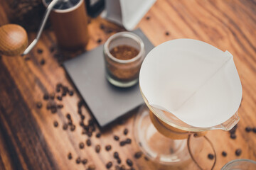 Close up filter coffee on wooden table with zipper bag coffee. The process of making drip coffee.