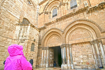 Unknown Worshipper Looking at the Church of Holy Sepulchre, Christian Quarter of Old City Jerusalem, where Jesus Christ was Crucified.
