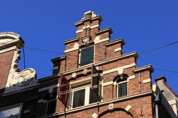 Amsterdam Historical House Facade with Stepped Gable and Sculpted Faces in the Red Light District