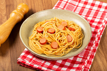 spaghetti pasta with sliced ​​sausages and tomato sauce.