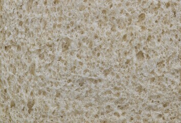 White bread texture, closeup slice with macro surface details. One of mankind's oldest staple foods.