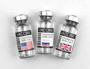 Vaccine research and development concept, vaccine vials with national flags of USA, UK and Russia, vaccination and immunization background