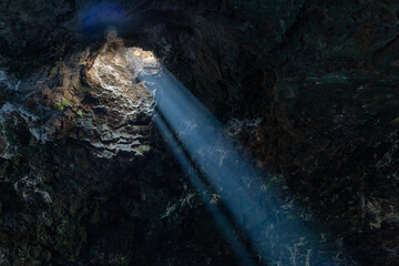 water flowing into the cave, water dragon in the cave with sun reflections