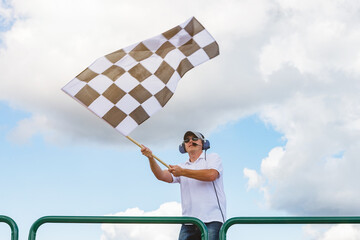 Man waves a checkered flag