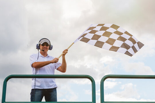 Man waves a checkered flag