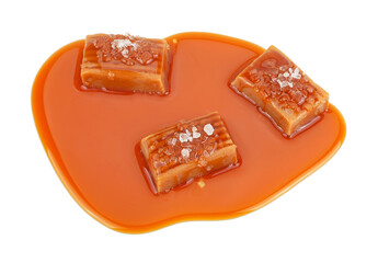 Salted toffee candies with caramel sauce isolated on a white background