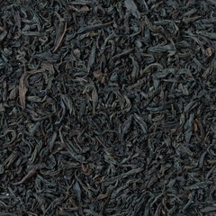 View from above. Large leaf tea background. Natural structure of dried tea leaves. Black tea. Close-up