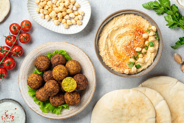 Chickpea dishes, falafel and hummus, on a concrete background, view from above, selective focus