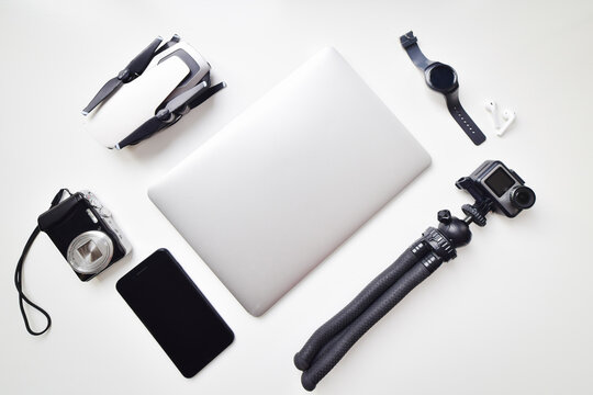 Flat Lay Daily Vlogging Lightweight Gadget Travel Set Up Isolated On White Table Background: Compact Camera, Phone, Watch, Compact Camera, Drone, Notebook, Earphones