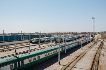 Parking for diesel electric locomotive. Vintage green train cars at the station.
