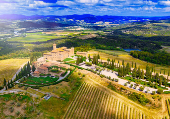 Fototapeta na wymiar Aerial view of Banfi Castle from drone in Tuscany, spring season