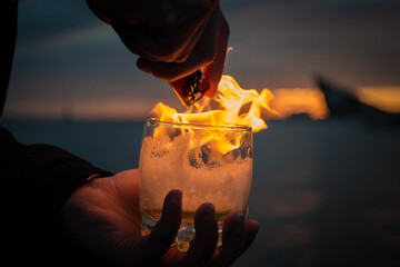 Glass with fire at sunset