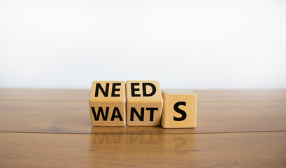 Wants or needs symbol. Turned cubes and changed the word 'wants' to 'needs'. Beautiful wooden table, white background, copy space. Valentines day and wants or needs concept. - obrazy, fototapety, plakaty