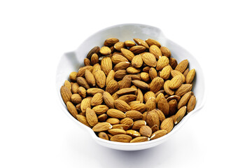 A group of shelled almonds in a white bowl. Perfect shot for breakfast, vegan, health and wellness.