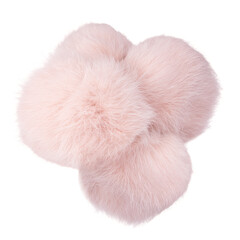 Close up of beige rabbit fur pompoms isolated on white background