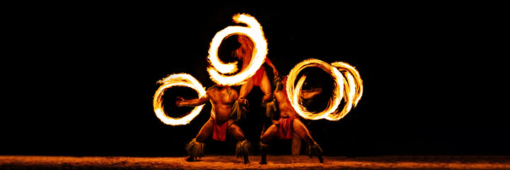 Luau hawaiian fire dancers motion blur tourist attraction in Hawaii or French Polynesia,...