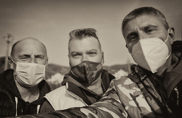 Selfie of three male photographers wearing mask in covid emergency