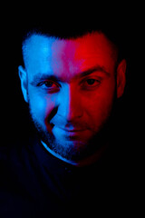 A guy in a jacket and shorts sits on the floor with a laptop on a white background. Distance learning and quarantine education. Coronavirus epidemic. Self-isolation, home quarantine.