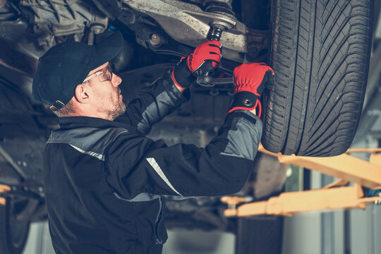 Automotive Mechanic Replacing Car Suspension Elements
