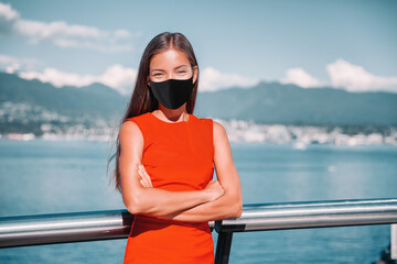Asian businesswoman wearing face mask as coronavirus prevention. Confident multiracial business lady outside portrait smiling during pandemic in Vancouver, Canada. - Powered by Adobe