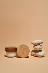 Natural skincare cream next to stack of stones