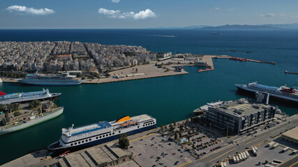 Fototapeta premium Aerial drone panoramic photo of famous and busy port of Piraeus where passenger ships travel to popular Aegean destinations, Attica, Greece