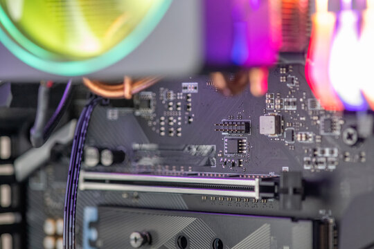 Motherboard with components and flashing lights inside a pc