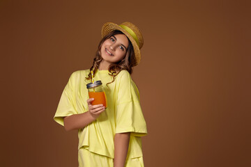 Portrait of cute little child girl drinking orange juice