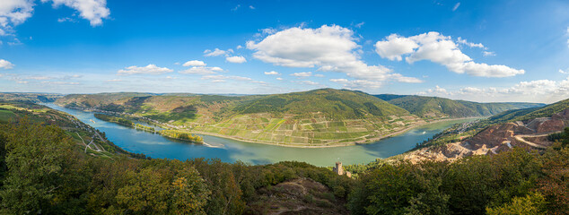 Fototapeta premium Panoramic image over an area of the middle Rhine valley in Germany with medieval castle and vineyards