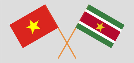 Crossed flags of Vietnam and Suriname. Official colors. Correct proportion