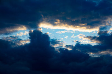 Fototapeta premium Blue sky between dark blackish storm clouds