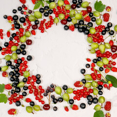 Naklejka na ściany i meble Fresh ripe berries, cherries, raspberries, currants and gooseberries on white background in form of frame. Place label in center. Summer berries, harvest concept, vitamin food, veganism.