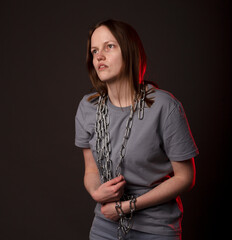 Young woman ties with chain, suffer from despair, psychological problems. Unhappy person with heavy...