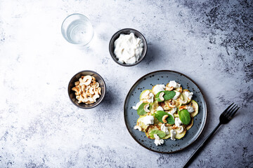Zucchini ricotta cashew mint salad in a plate