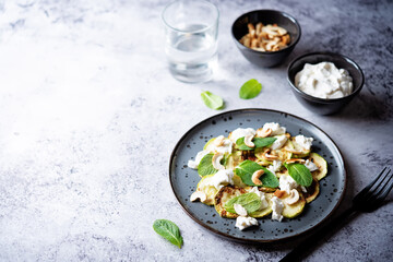 Zucchini ricotta cashew mint salad in a plate