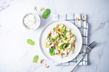 Zucchini ricotta cashew mint salad in a plate