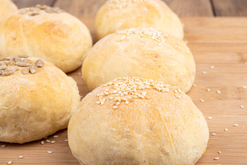 Selective focus on homemade buns with sesame and sunflower seeds.