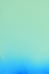 blue spray paint on a soft green colored paper background
