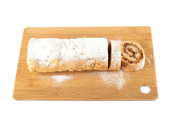 Sliced apple roll on a wooden cutting board.