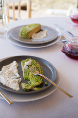 Pistachio roll is located on a plate for delicious Brunch on a summer terrace in a rustic romantic style