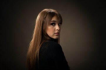 Young woman looking at camera isolated on black background