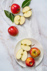 Plate with ripe multicolored apples on rustic tile.Top view.Still life.