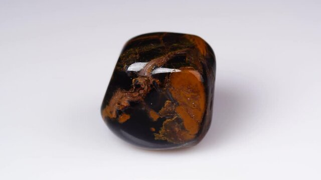 natural jaspelite gemstone on the white background on the turning table