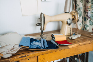Supporting local, Tailoring small business. Seamstress, dressmaker, designer retro style workplace. Sewing machine with fabric samples, Threads and needles.