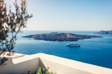 Santorini landscape of Aegean sea with big passenger cruise ship by volcano island. Caldera view. Tholos Naftilos