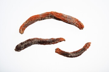 Rotting and moldy three carrots with black spots isolated on white